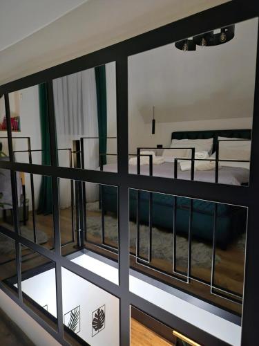 a view through a window of a room with a bed at Holiday house Aria Vučedol in Vukovar