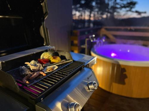 a grill with meat and vegetables on top of it at THE BLISS FUJI - YAMANAKAKO private Sauna Villa with 100m2 Dog Run in Yamanakako