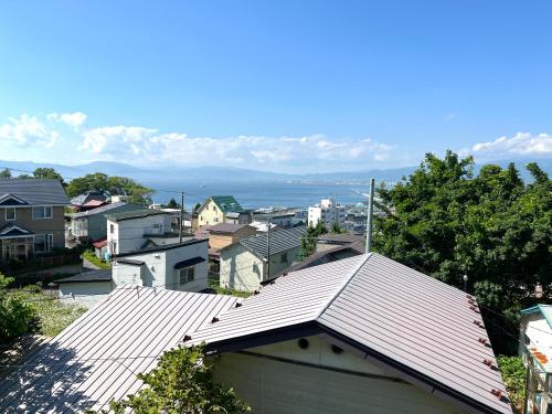 a view of a city with houses and a roof at Local Stay Hakodate in Hakodate