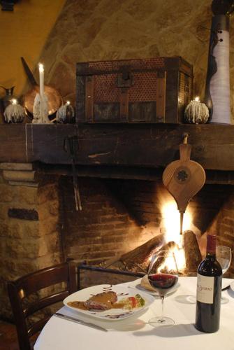 a table with a plate of food and a bottle of wine at Apartamentos El Tiempo Madrid in Madrid