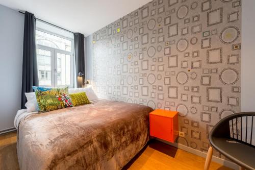 Smartflats - Royal Brussels tesisinde bir odada yatak veya yataklar