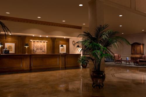 a lobby with a waiting area with a potted plant at Millennium Durham in Durham