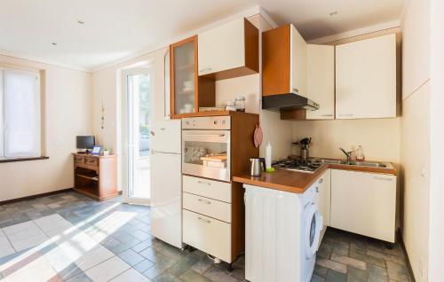 a kitchen with white cabinets and a stove top oven at Rio Molino 1 in Stresa