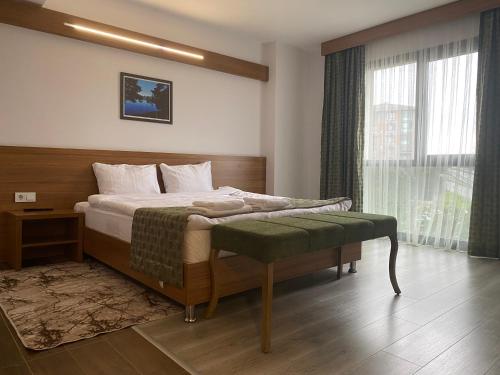 a bedroom with a bed and a large window at BUSINESS EXPRESS HOTEL in Kapaklı