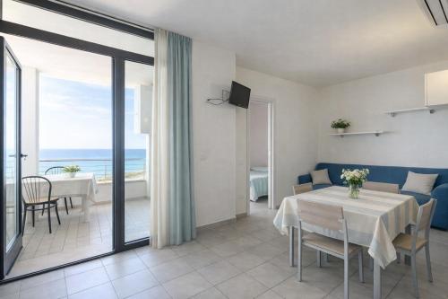 a living room with a table and a view of the ocean at AMA Marena Apartments in Pesaro