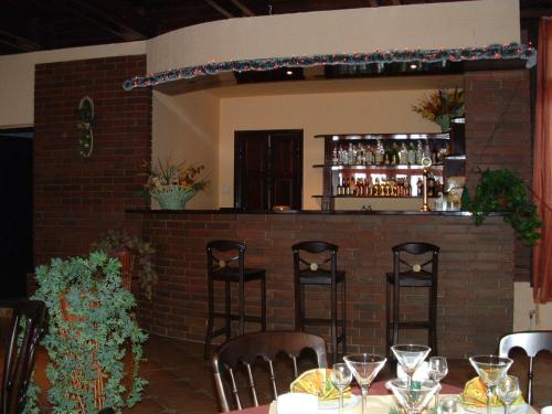 a bar in a restaurant with tables and chairs at Hotel Junior in Zamość