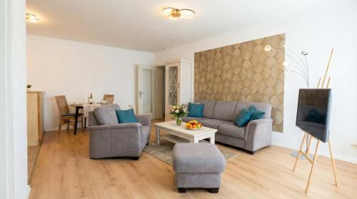 a living room with a couch and a table at FeWo Jette in Warnemünde