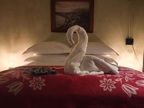 a towel swan sitting on top of a bed at Hótel Tindastóll in Sauðárkrókur