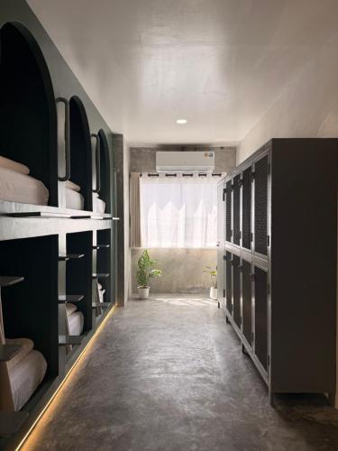 a dressing room with black shelves and a window at Cheevit Cheeva Koh Tao Hostel in Ko Tao
