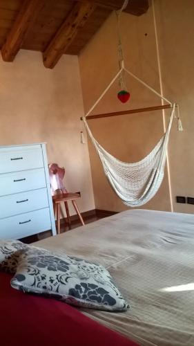 a hammock hanging over a bed in a bedroom at Casa Maia in Padova