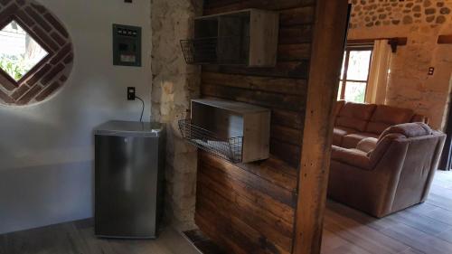 a living room with a chair and a television at La Mora Casa de Campo in Huasca de Ocampo