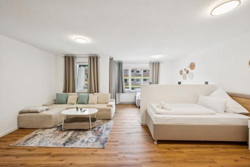 a living room with a couch and a table at Ramoni Apartments - Abendgold in Enzklösterle