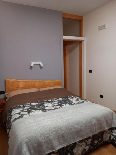 a bedroom with a bed with a wooden head board at Enoturismo Dofinè in Due Carrare