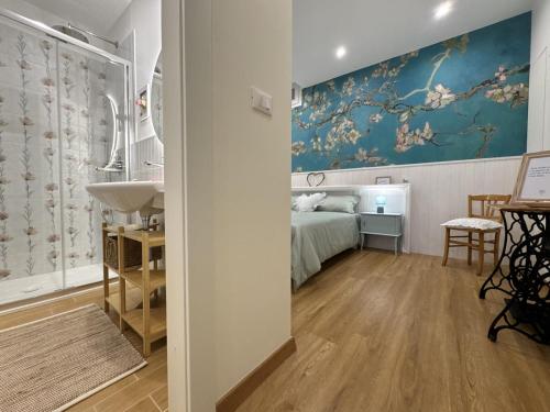 a bedroom with a bed and a sink in a room at Le Jardin Fleuri in Castelluccio Valmaggiore