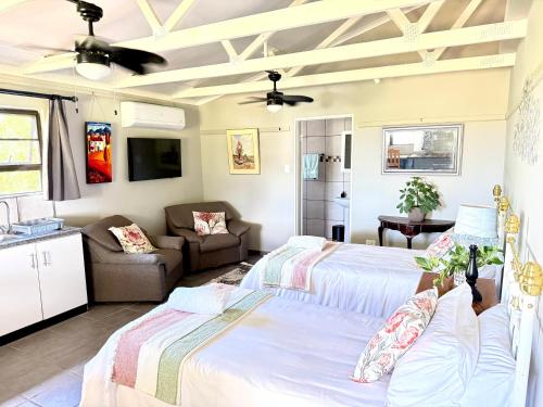 a bedroom with two beds and a couch at Sanctuary Guesthouse in Kimberley