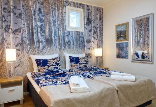 a hotel room with a bed with a phone on it at Hotel Hiisi Hill in Jämsä