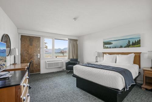 a hotel room with a bed and a television at Americas Best Value Inn Polson in Polson