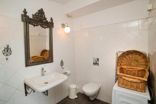 a bathroom with a sink and a toilet and a mirror at Seafront Casa Azul Villa - Getaway in Kalymnos in Kalymnos