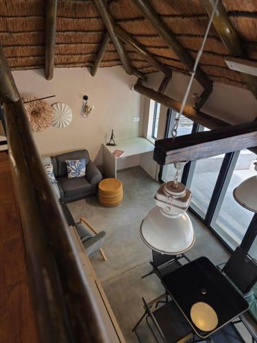 an overhead view of a living room with a couch and chairs at Little Orvyll's Studio- Near Kruger National Park, you can add up to six guests at our Larger Property Croc Orvyll's Kruger Lodge and all stay in one location in Marloth Park