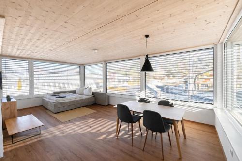 a living room with a table and chairs and a couch at Staminé in Hochfilzen