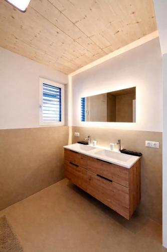 a bathroom with a sink and a mirror at Staminé in Hochfilzen