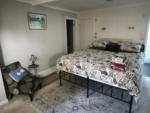 a bedroom with a bed and a chair at Groombridge 1 Bed self catered flat, can sleep 2 in Groombridge