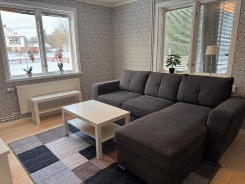 a living room with a couch and a table at Dalagård i Insjön in Insjön