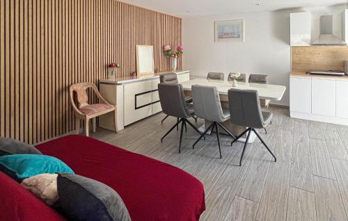 a kitchen with a table and chairs in a room at Maison Avec Piscine in Coutances
