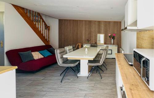 a kitchen and living room with a table and chairs at Maison Avec Piscine in Coutances
