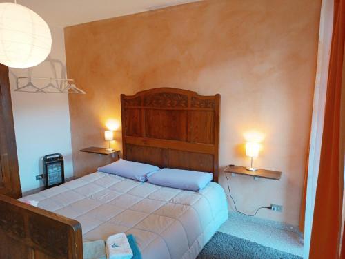 a bedroom with a bed with two pillows on it at Risveglio 16 in San Giovanni
