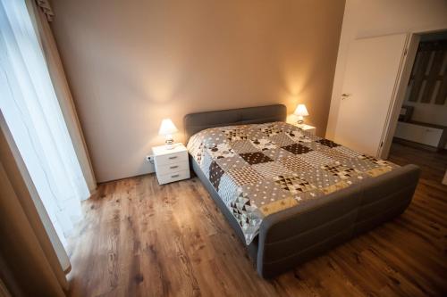 a bedroom with a bed with two lamps on it at Palatium Bad Ems in Bad Ems