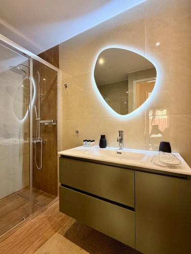 a bathroom with a sink and a shower and a mirror at B2 Pausilipon Park Corner in Karditsa