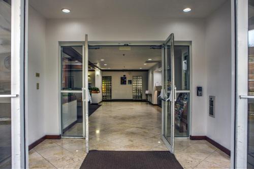 an entrance to a building with glass doors at Motel 6-Dallas, TX - Northwest in Dallas