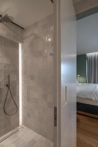 a bathroom with a shower and a bedroom with a bed at Coco-mat Athens BC in Athens