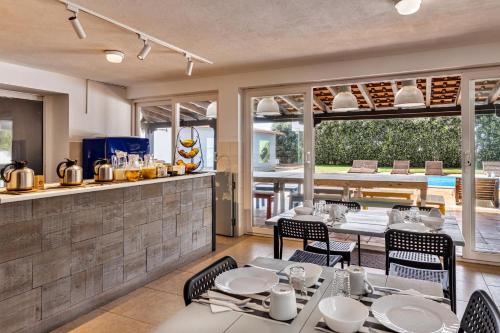 a restaurant with tables and chairs and a kitchen at FreeSurfCamp in Peniche