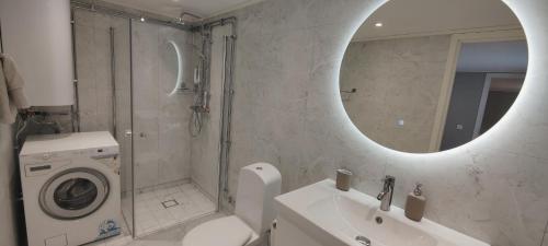 a bathroom with a washing machine and a sink at Snäckstrand Guesthouse in Färjestaden
