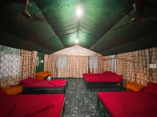 a room with two beds and red pillows at Dandeli River Valley Resort in Dandeli