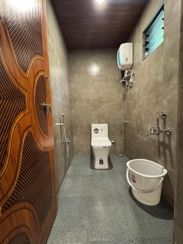 a bathroom with a toilet and a sink at Dandeli River Valley Resort in Dandeli