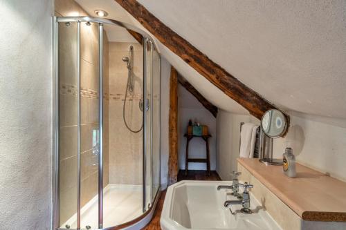 a bathroom with a shower and a sink at Finest Retreats - Syncocks Farm Cottage in Petrockstow