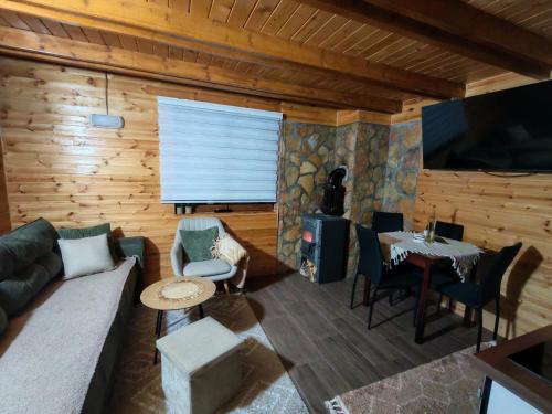 a living room with a couch and a table at vikendica tarska car in Mitrovac