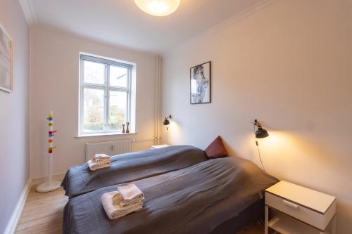 a bedroom with a bed and a window at Odinsvej Apartments - by Central Lyngby Apartments in Kongens Lyngby