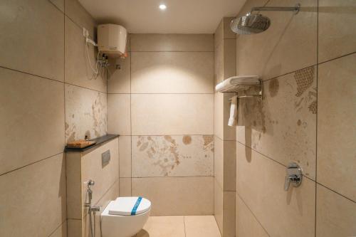 a bathroom with a toilet and a shower at MGM Whispering Meadows Yelagiri in Yelagiri