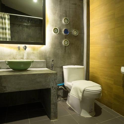 a bathroom with a white toilet and a sink at Pupha&Sila Home Resort in Betong