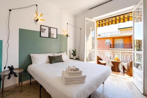 a bedroom with a bed and a large window at La casetta POP in Bordighera