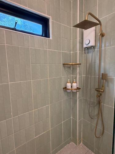 a shower with a shower head in a bathroom at Srithanu Escape 1 in Srithanu