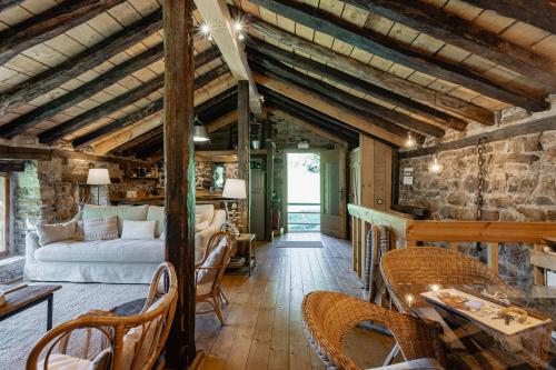 a living room with a bed and a table and chairs at Cabañas con Encanto in San Roque de Ríomiera