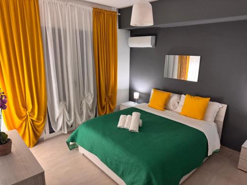 a bedroom with a large bed with yellow and green at Bella Tao Apart in Taormina