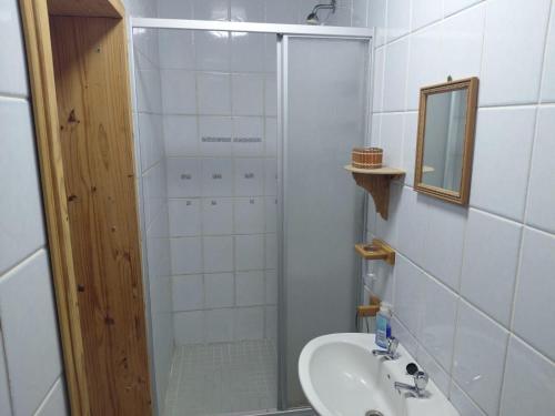 a bathroom with a shower and a sink and a mirror at Carey 43 in Bothaville