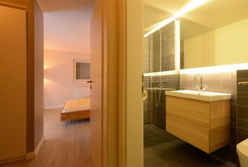 a bathroom with a sink and a mirror at Wenningstedt Beach Apartment in Wenningstedt