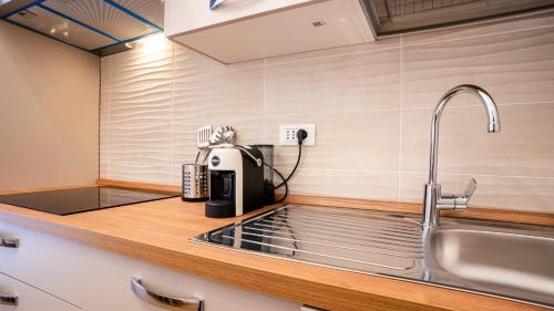 a kitchen with a sink and a coffee maker on a counter at Ramazzini District – Elegant Flat x8 in Milan